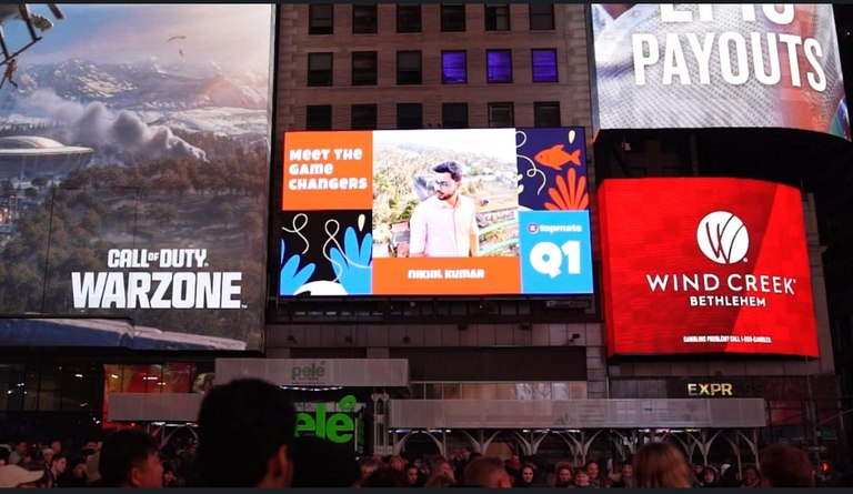 A Times Square billboard displaying Nikhil Kumar in Topmate's Meet the Game Changers showcase